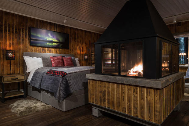 Roaring fire and bed at Loggers Lodge in Sweden