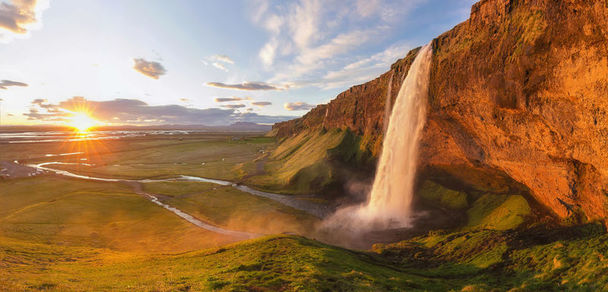 The Midnight Sun over Iceland's Seljalandsfoss Waterfall