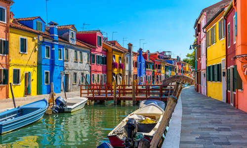 Street with colorful buildings and canal in Burano island, Venice, Italy