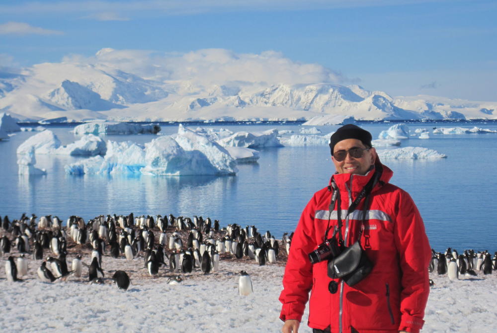 Wexas travel specialist Tim Tan with penguins in Antarctica