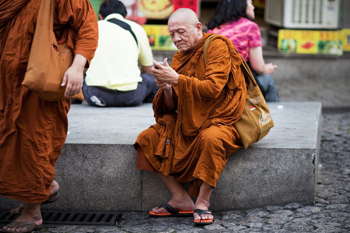 A monk checks his phone, Macau